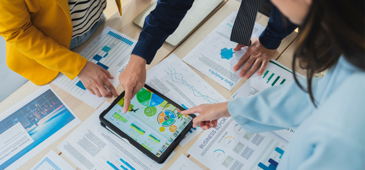 imageofgroupworkingtogetherovertabletanddocuments