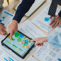 imageofgroupworkingtogetherovertabletanddocuments