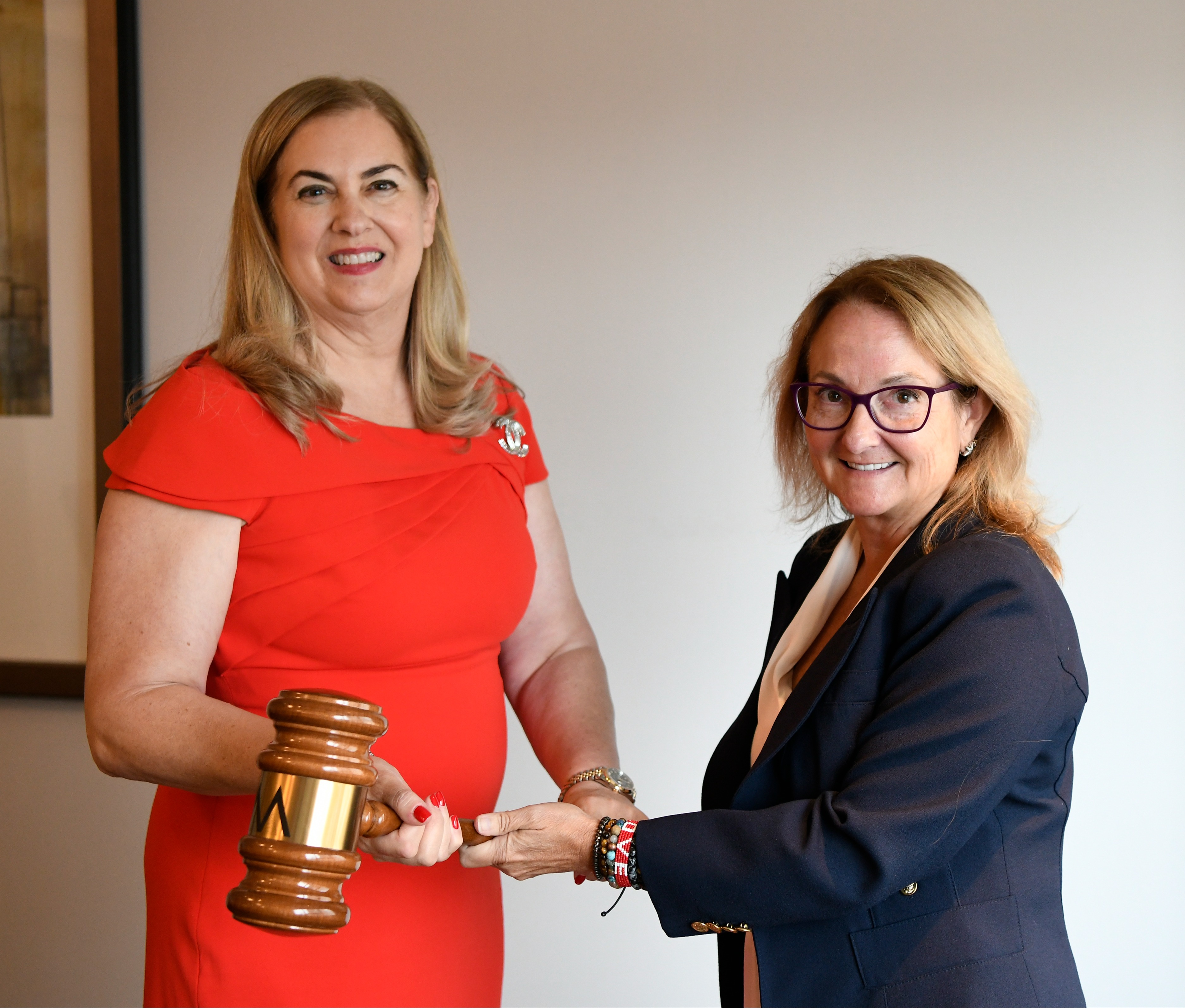 Image of the AOM 2023 gavel pass with Sharon Alvarez (incoming) and Amy Hillman (outgoing)