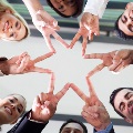 Imageofpeoplecreatingastarwithjoinedfingetips