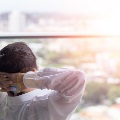 mansittingnearwindowdeepinthought
